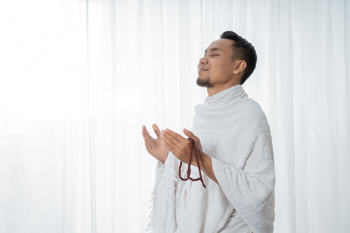 Muslim Asian Man Praying with Prayer Beads